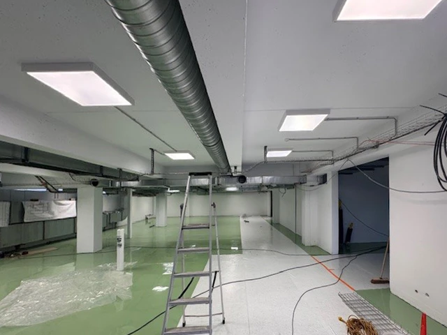 Espace de travail intérieur avec équipements de sécurité disposés sur plans architecturaux